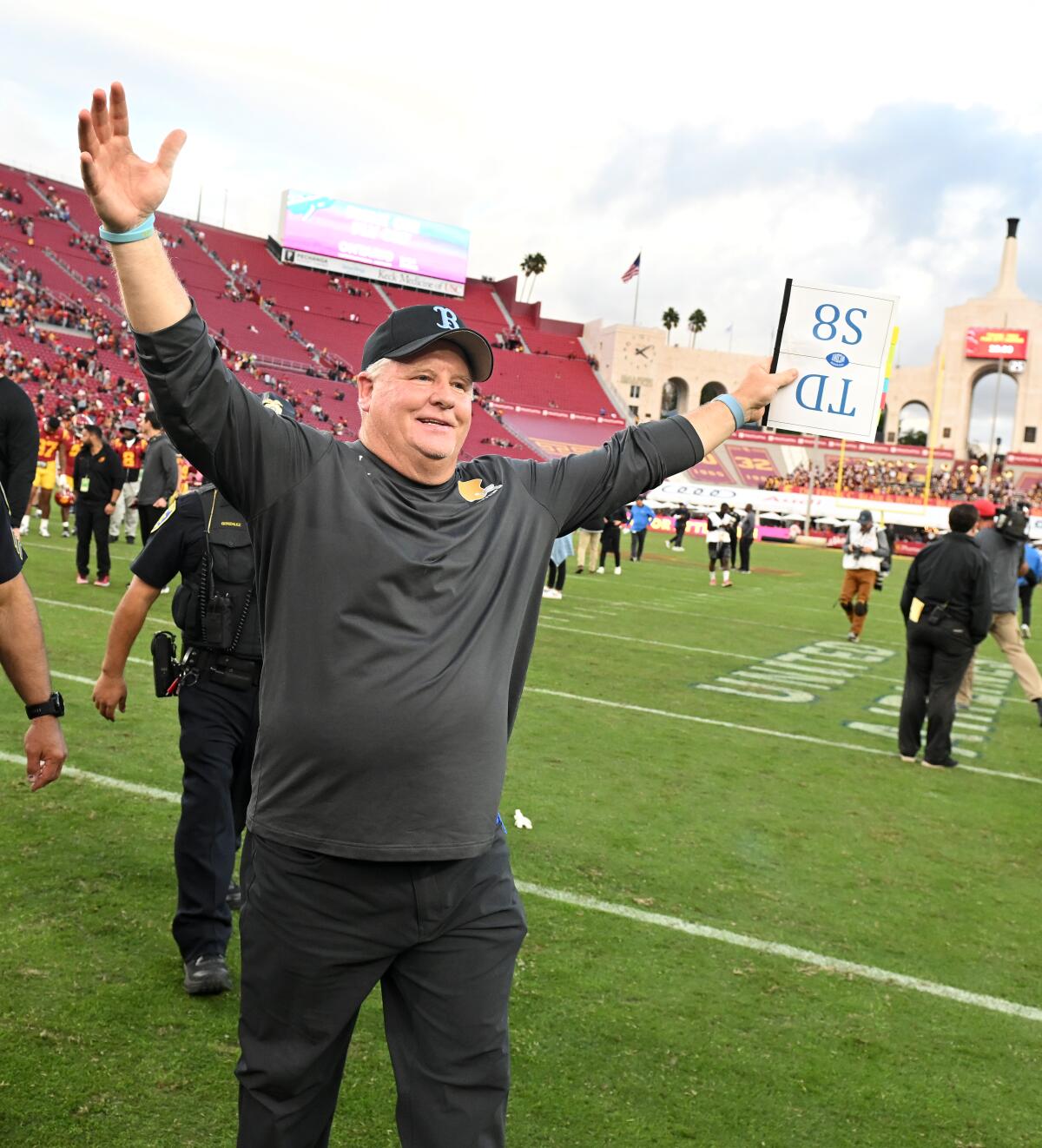 UCLA head coach Chip Kelly extends his arm while walking on the field at the Coliseum on Nov. 18.