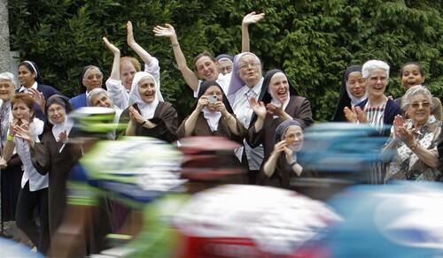 Nuns join the crowd as the pack passes through Lourdes during the 10th stage of the Tour de France cycling race between Pau and Hautacam in southern France.