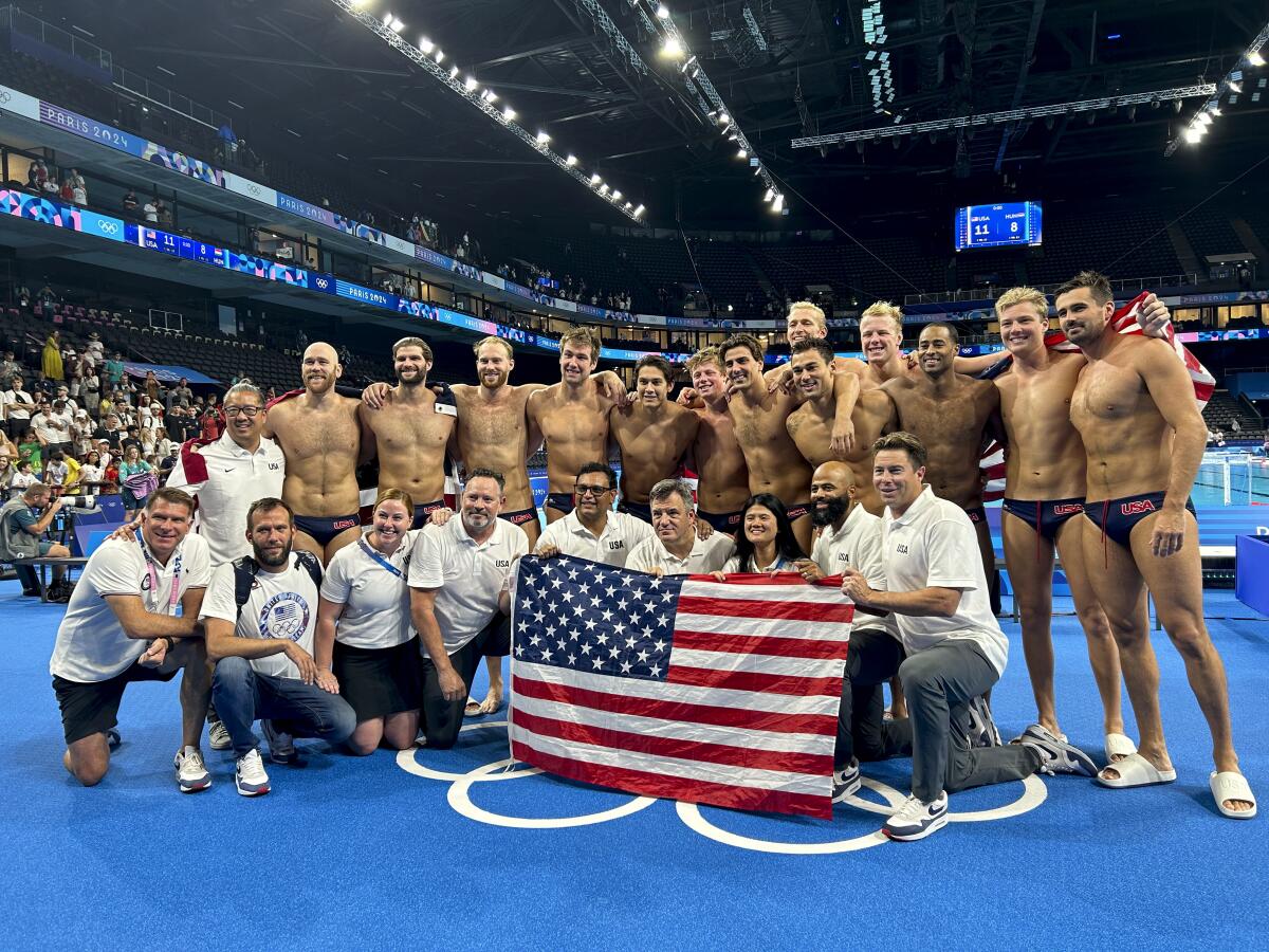 U.S. players and coaches celebrate after their bronze-medal win over Hungary at the Paris Olympics on Sunday.