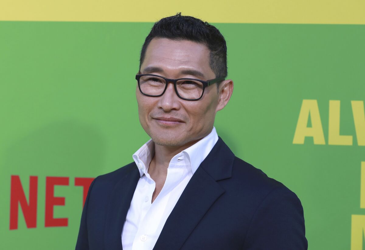 Daniel Dae Kim posing in glasses and a navy suit