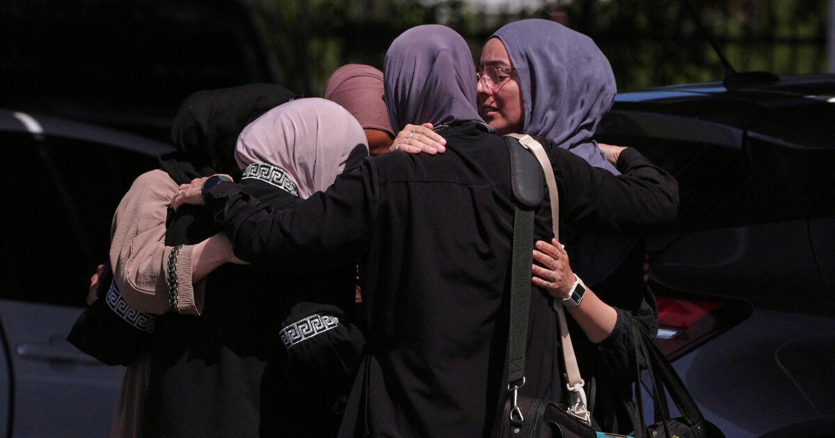 Photo: Los Angeles Times People embrace outside of the Islamic Center of San Diego, the day after a shooting, Tuesday, May 19, 2026, in San Diego