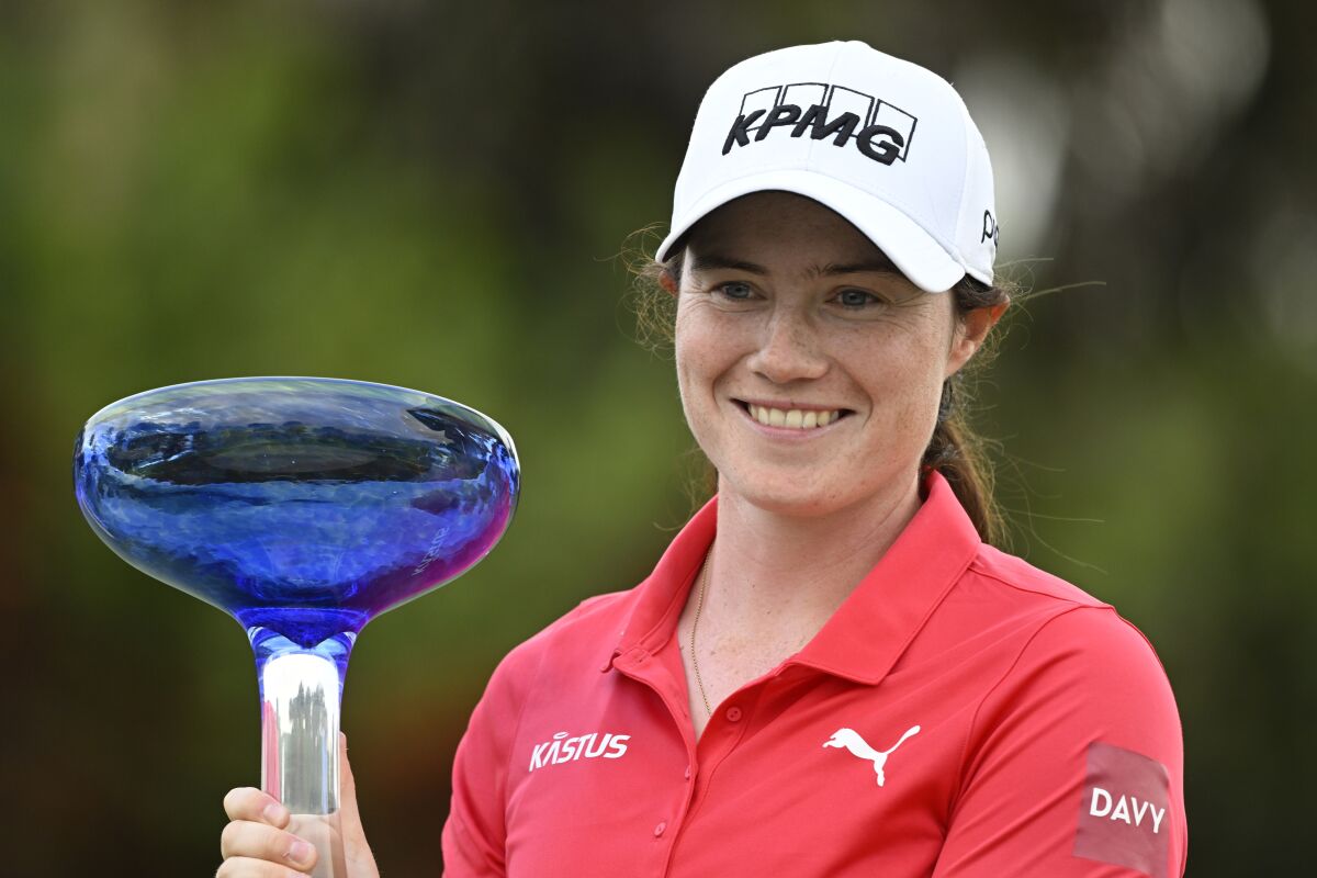 Leona Maguire holds the winner's cup after winning the LPGA Drive On Championship golf tournament at Crown Colony Golf & Country Club, Saturday, Feb. 5, 2022, in Fort Myers, Fla. (AP Photo/Steve Nesius)
