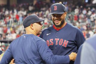 Kenley Jansen #74 of the Boston Red Sox celebrates with manager Alex Cora #13 after earning the 400th save of his career 