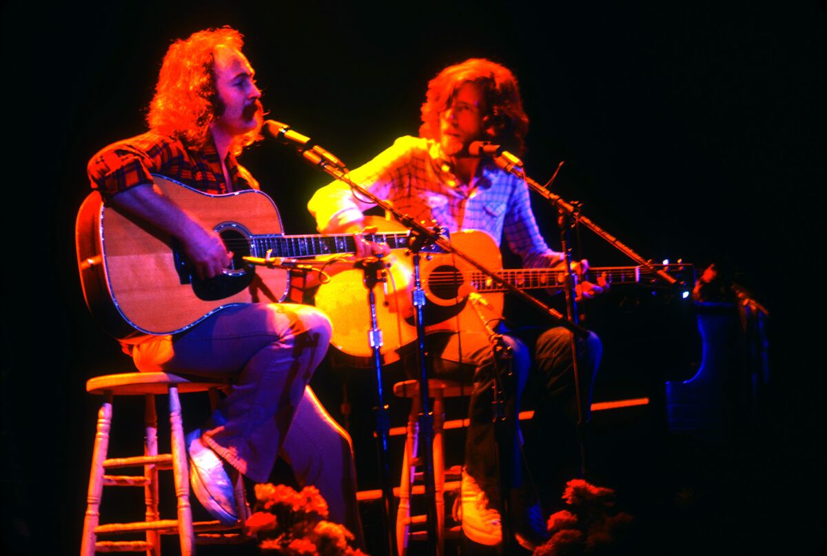 David Crosby and Graham Nash are shown at a 1974 Crosby, Stills, Nash & Young concert in Oakland.