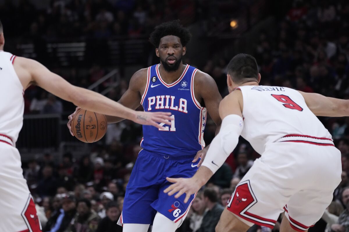Philadelphia 76ers' Joel Embiid brings the ball up during the first half of an NBA basketball game against the Chicago BullsWednesday, March 22, 2023, in Chicago. (AP Photo/Charles Rex Arbogast)