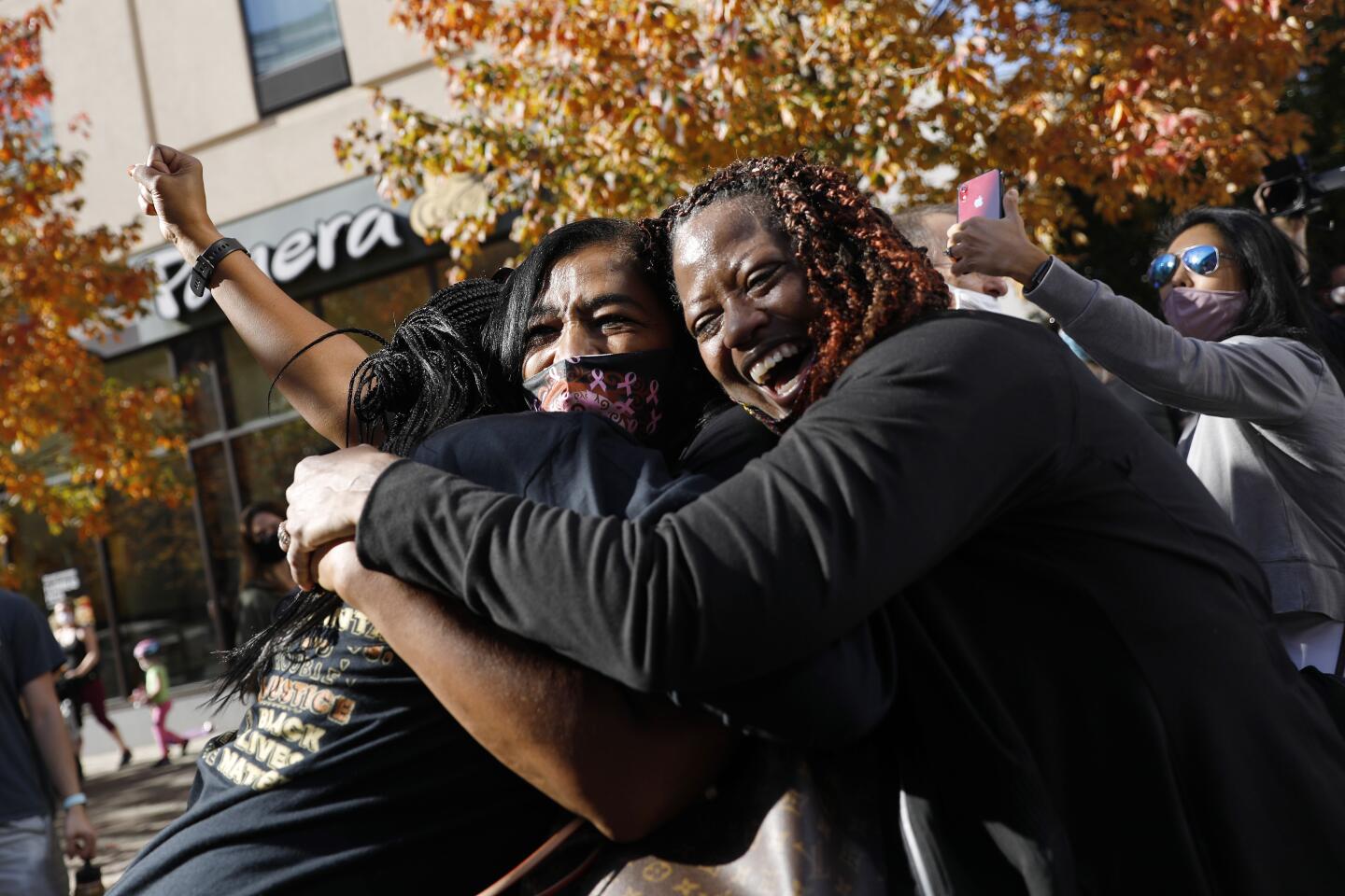 Two women in Philadelphia hug joyously while celebrating Democrat Joe Biden's victory over President Trump.