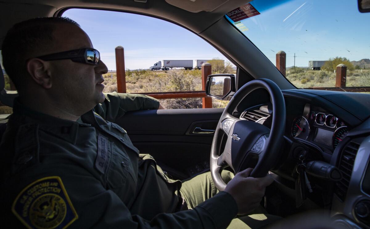 U.S. Customs and Border Protection agent Daniel Hernandez patrols along a dirt road yards from Mexico's Highway 2, which closely parallels the U.S.-Mexico border in Cabeza Prieta National Wildlife Refuge, Ariz., on March 5.