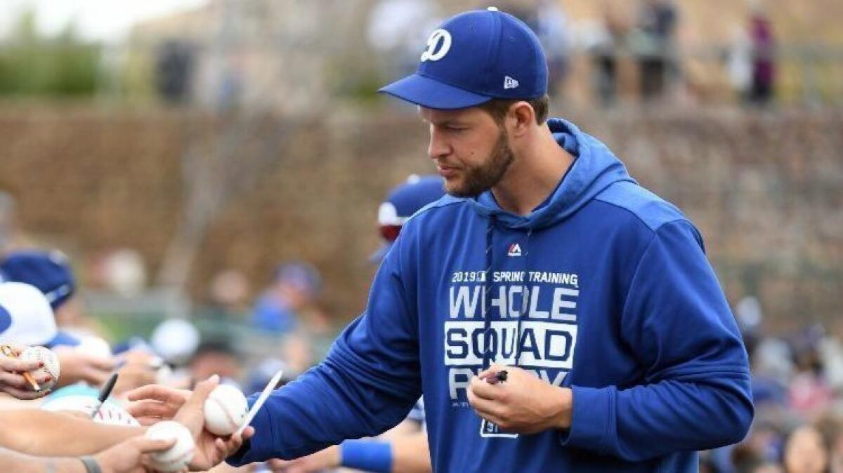 Dodgers starting pitcher Clayton Kershaw signs autographs at Camelback Ranch before a game against the San Francisco Giants on March 11.