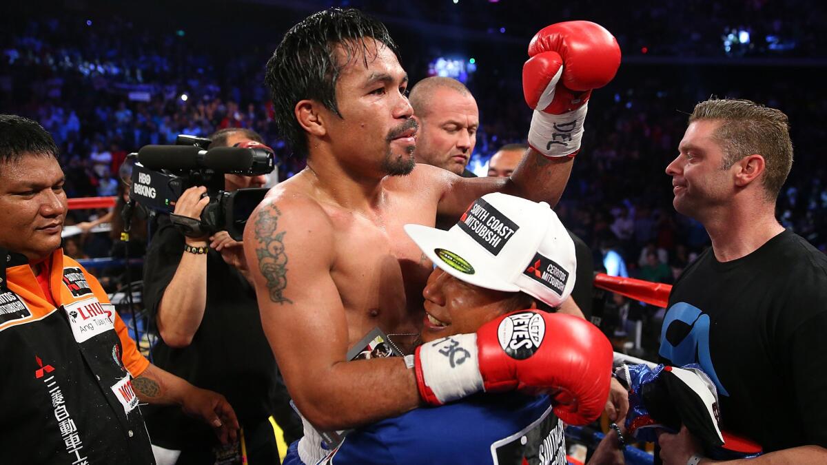 Manny Pacquiao celebrates after defeating Chris Algieri in their welterweight title fight in Macao on Nov. 23.