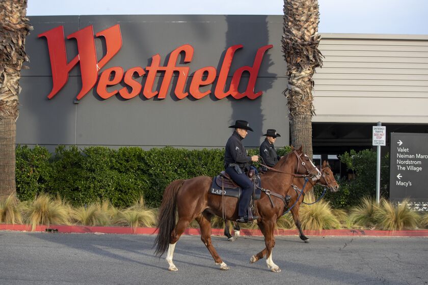 CANOGA PARK, CA - December 06 2021: LAPD mounted unit officers Daniel, right, and Morales, left, patrol the Westfield Topanga shopping mall on Monday, Dec. 6, 2021 in Canoga Park, CA. (Brian van der Brug / Los Angeles Times