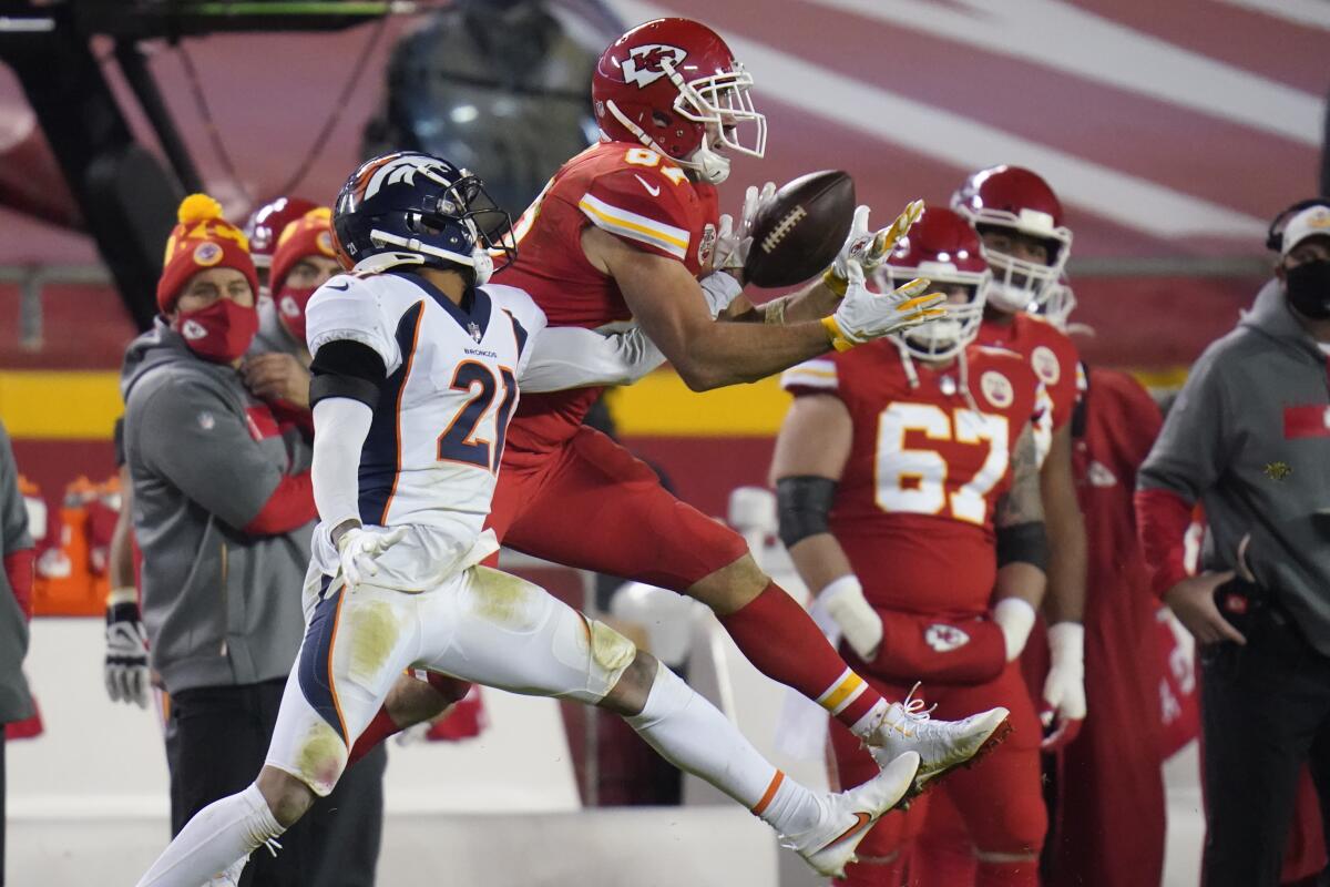 Denver Broncos cornerback A.J. Bouye (21) breaks up a pass intended for Kansas City Chiefs tight end Travis Kelce (87) in the second half of an NFL football game in Kansas City, Mo., Sunday, Dec. 6, 2020. (AP Photo/Jeff Roberson)