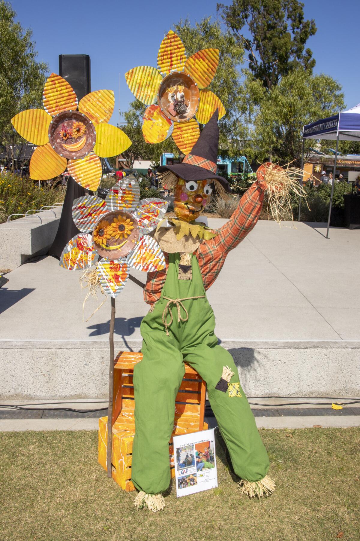A blossom display adorns a scarecrow entry called "Fred Fall and the Sunflowers" Saturday at Costa Mesa's Lions Park.