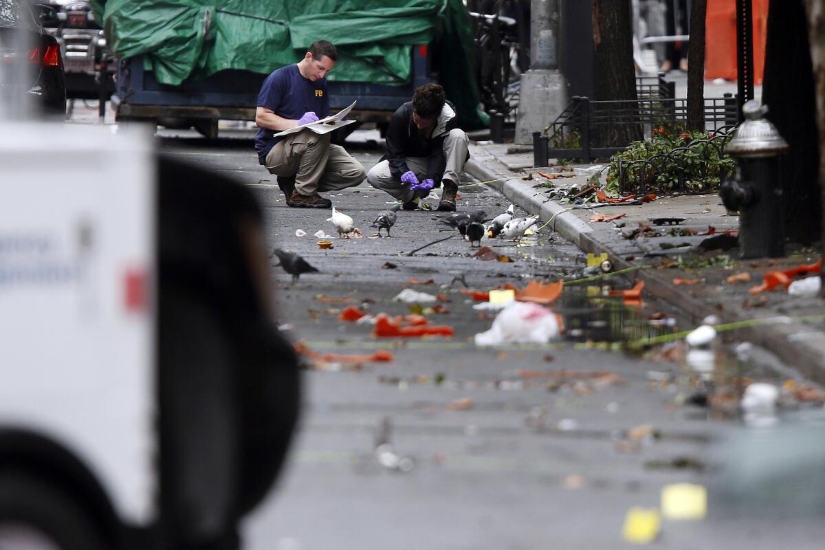 Investigators on Monday examine the scene of Saturday's explosion on West 23rd Street in Manhattan's Chelsea neighborhood.