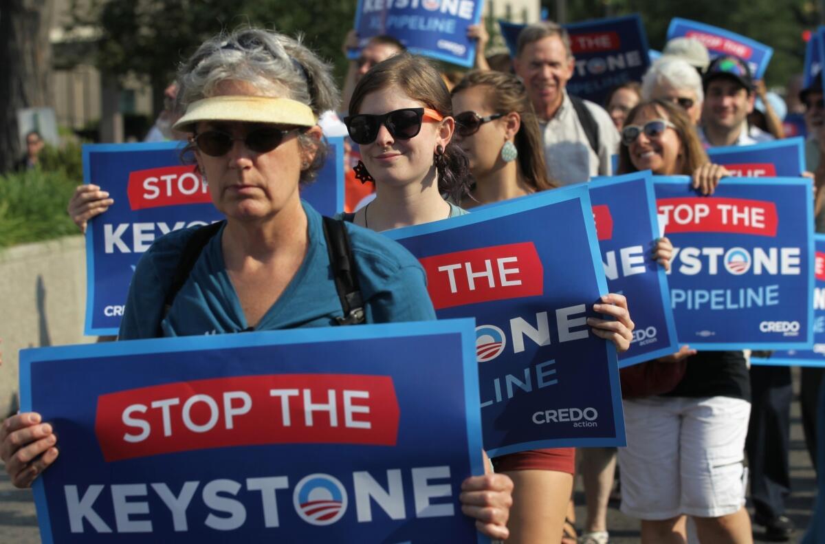 Activists march to State Department headquarters in Washington to protest against the Keystone XL pipeline.