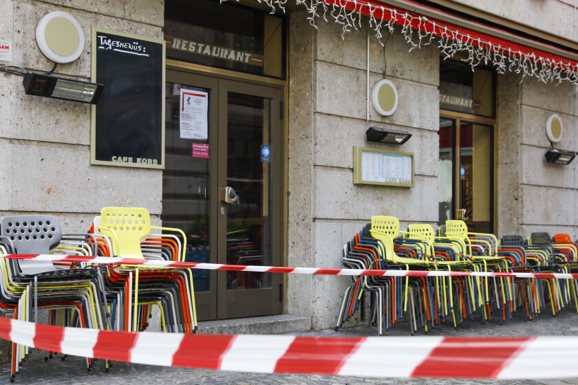 Due to the lockdown, restaurants are closed and seats are blocked off in Vienna, Austria, Tuesday, Nov. 30, 2021. (AP Photo/Lisa Leutner)