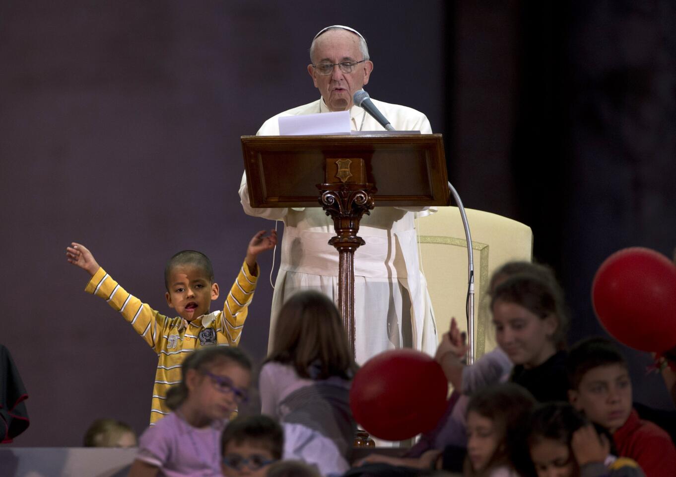 As Pope Francis spoke during a Vatican celebration of families, a young boy wandered onto the stage in St. Peter's Square.