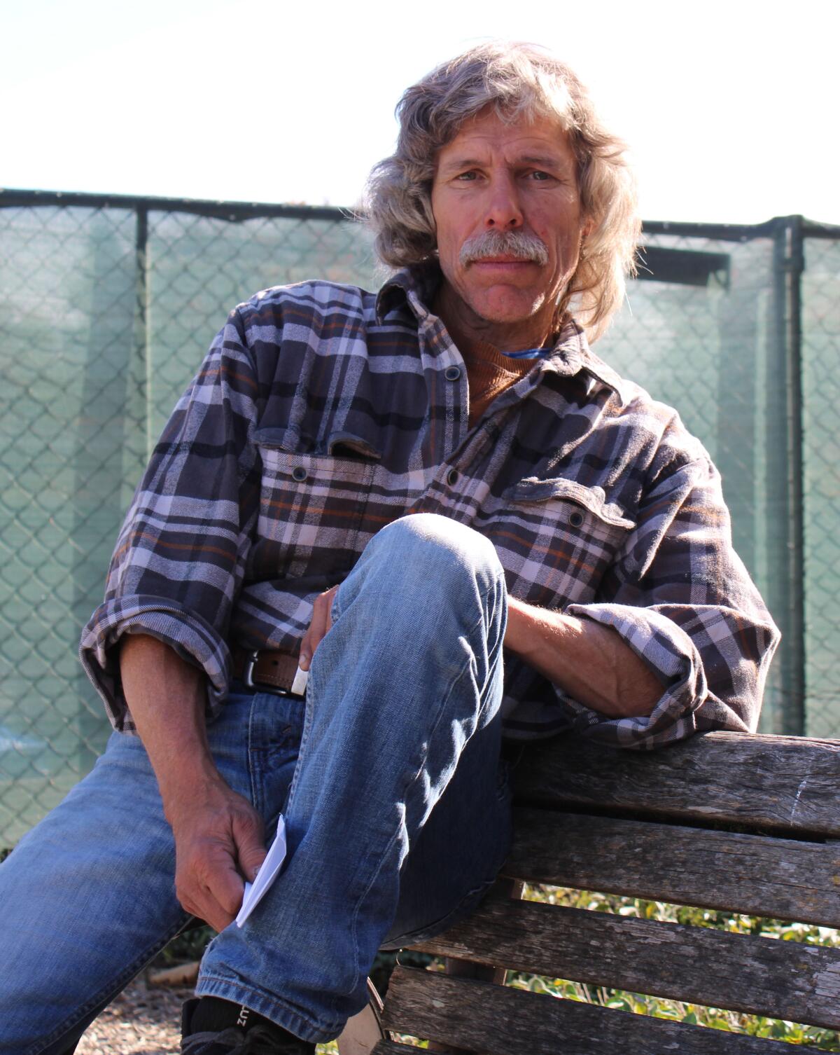 James Carver sits on a bench.