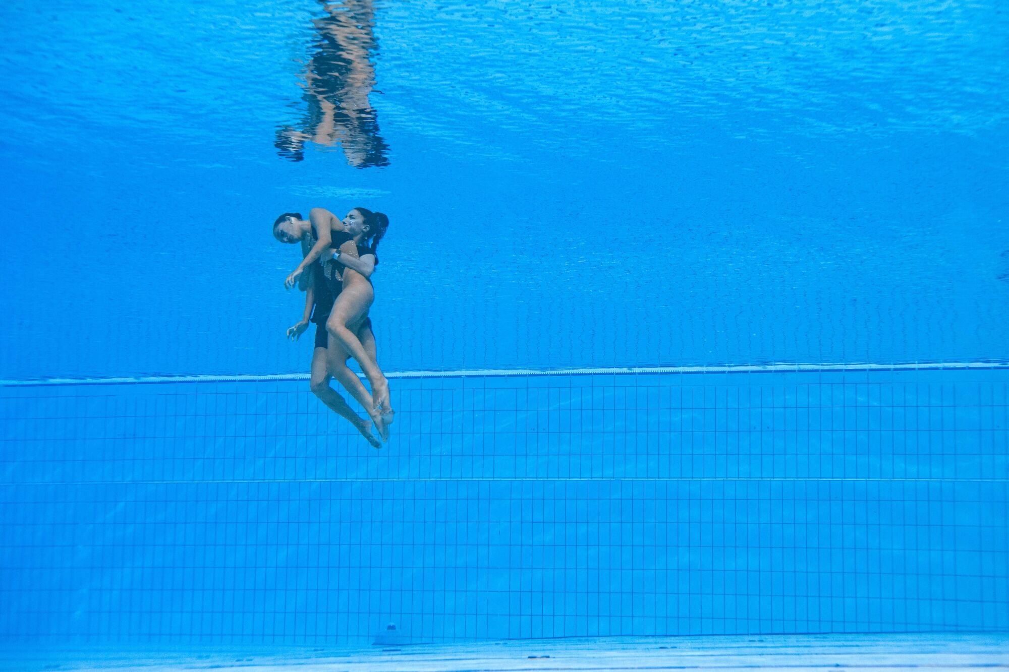 Anita Alvarez, left, is rescued from the bottom of the pool 