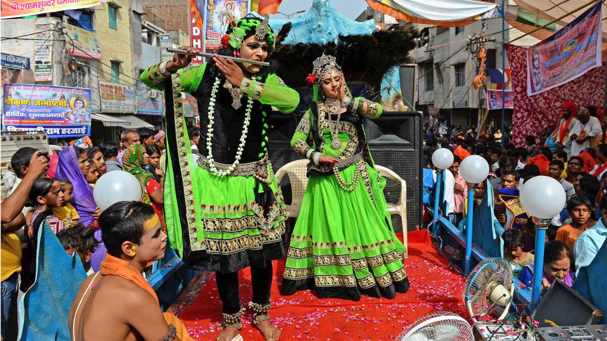 Indian Hindus dressed as the Hindu God Lord Krishna, left, and his consort Radha take part in a procession on the eve of Janmashtami, which marks Krishna's birth, in New Delhi, on Sept 3.