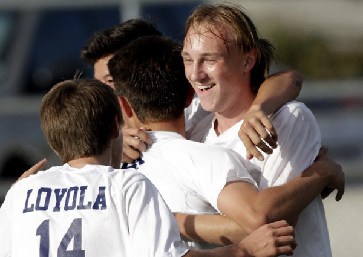 Ryan Savitt celebrates with teammates after a goal during a 3-0 victory over West Torrance in a playoff game on Tuesday.