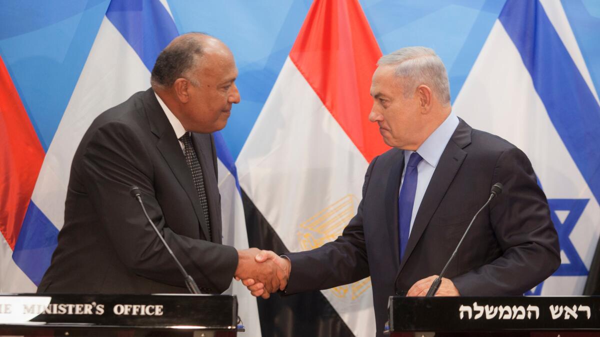Israeli Prime Minister Benjamin Netanyahu, right, shakes hands with Egyptian Foreign Minister Sameh Shoukry in Jerusalem on July 10, 2016.