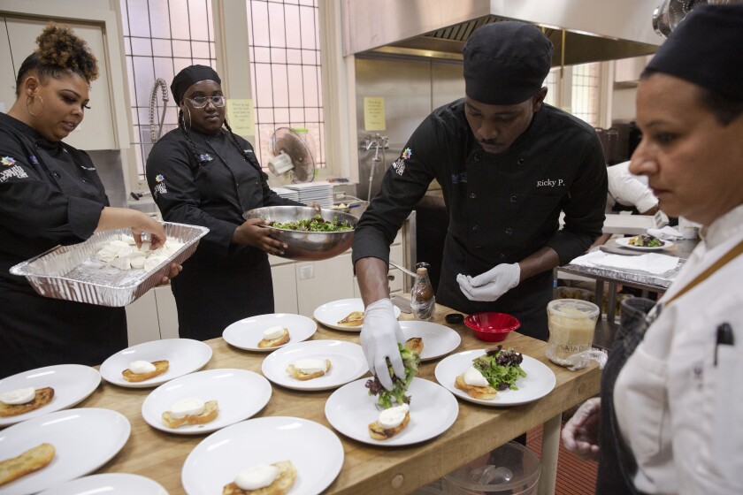 Young chefs prepare salads in a culinary apprenticeship program
