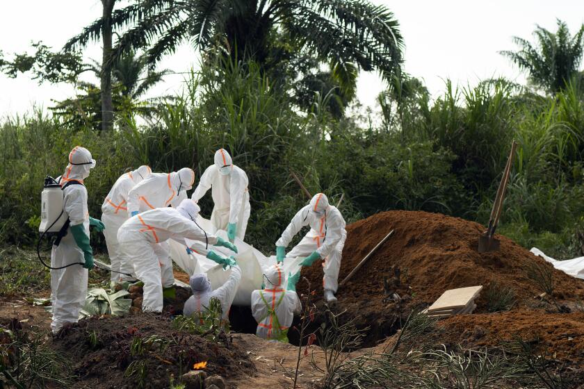 FILE - In this Sunday, July 14, 2019 file photo, an Ebola victim is put to rest at the Muslim cemetery in Beni, Congo. Eastern Congo on Thursday, June 25, 2020 has marked an official end to the second deadliest Ebola outbreak in history that killed 2,280 people over nearly two years as armed groups and community mistrust undermined the promise of new vaccines. (AP Photo/Jerome Delay, File)