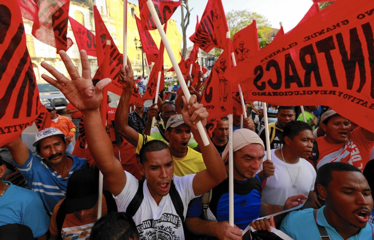 Panamanian labor union members march outside the presidential palace in Panama City on Feb. 26, 2015, to protest corruption cases.