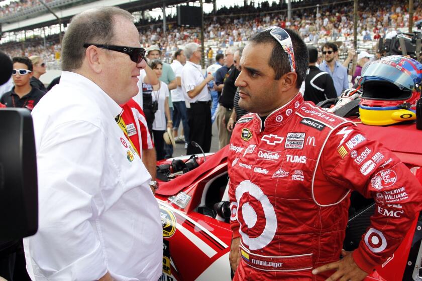 NASCAR Sprint Cup driver Juan Pablo Montoya, right, speaks with team owner Chip Ganassi before the start of the 2010 Brickyard 400 at Indianapolis Motor Speedway.