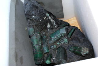 The Bahia Emerald contains nine dazzling crystals encased in a rough black rock