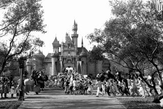 FILE - In this Sunday, July 17, 1955 file photo, children sprint across a drawbridge and into a castle that marks the entrance to Fantasyland at the opening of Walt Disney's Disneyland in Anaheim, Calif. Fantasyland had been closed until late in the day. (AP Photo)