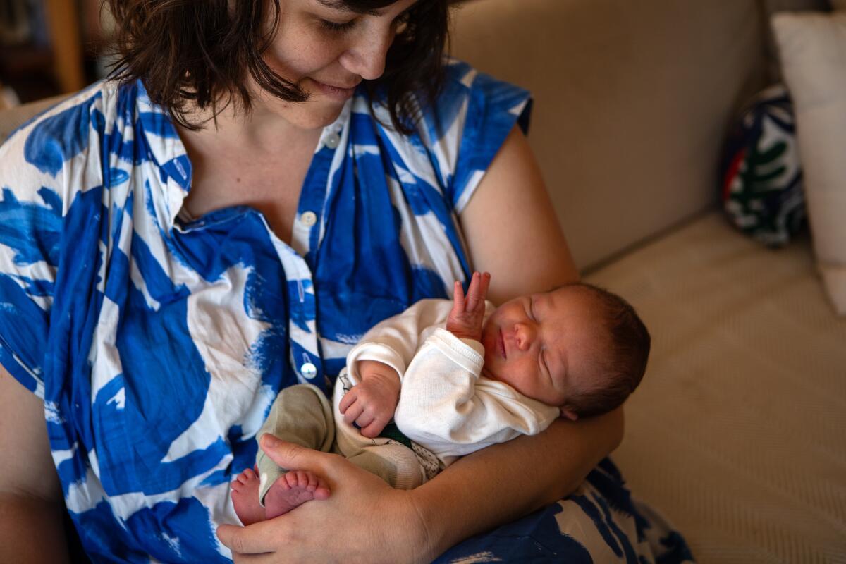 Megan Costello holds her infant son Fintan Cummins in Los Angeles. 
