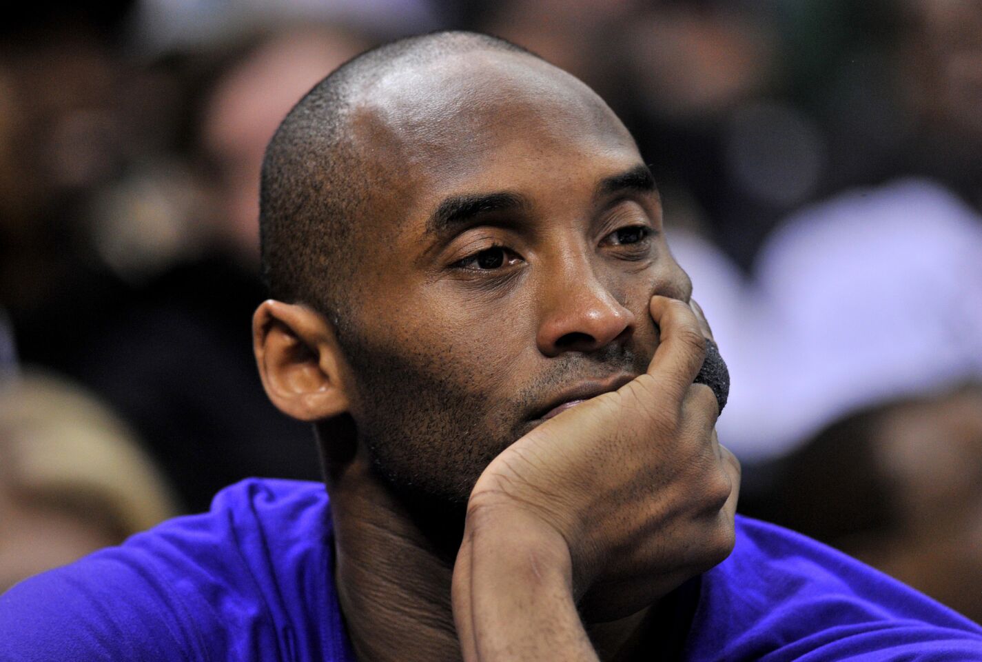 Kobe Bryant watches sits on the bench in the first half of a game against the Memphis Grizzlies on Feb. 26 at Staples Center.