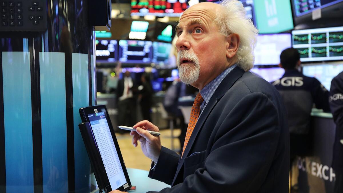 Traders work on the floor of the New York Stock Exchange.