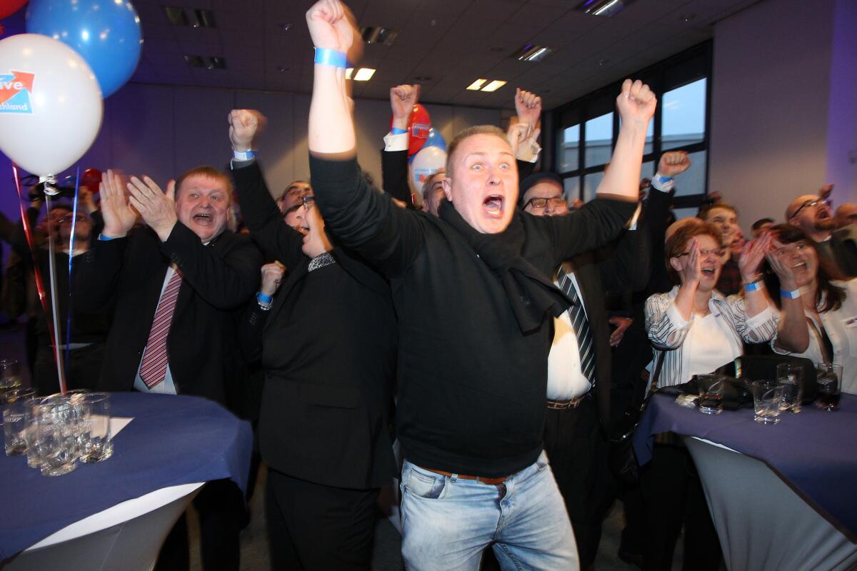 Supporters of the right-wing populist party Alternative for Germany react after state election exit poll results are announced at an election party in Magdeburg, eastern Germany, on Sunday.