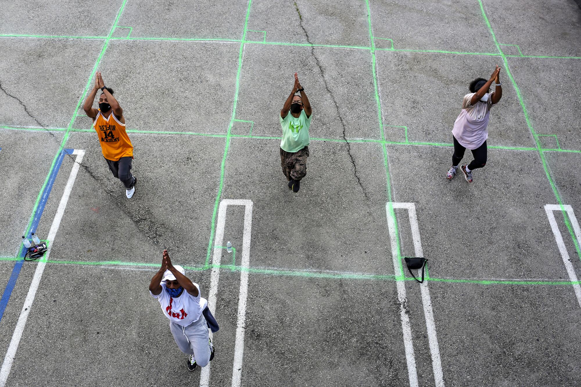 A dance class is held in a parking lot