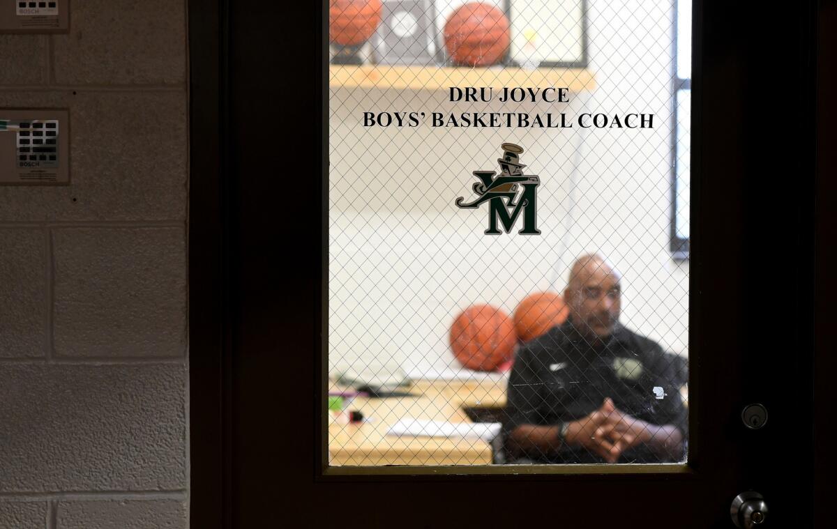 Basketball coach Dru Joyce Sr. sits in his office at St. Vincent-St. Mary High in Akron. He coached LeBron James and his teammates to three state championships.