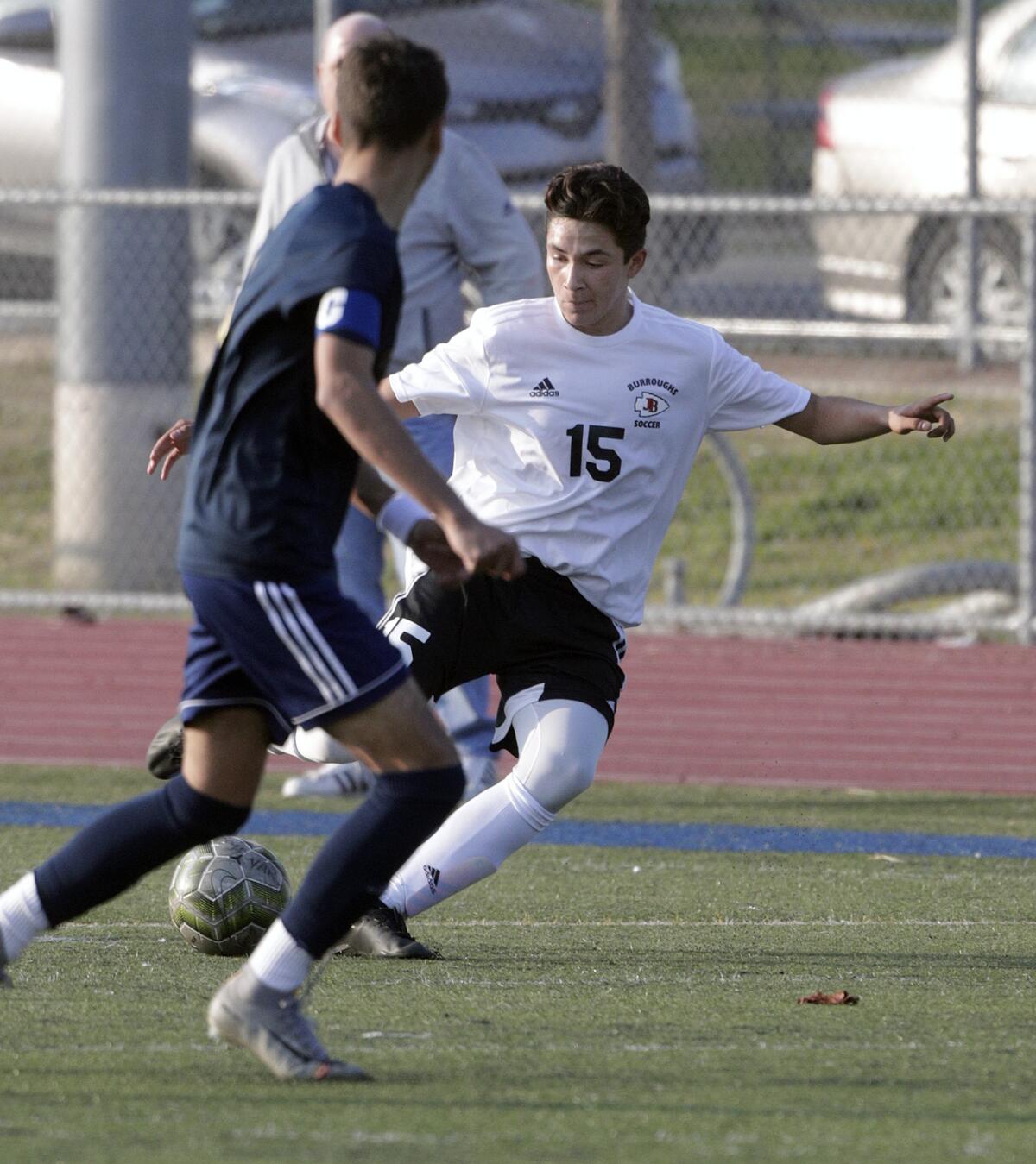 Burroughs' Alex Leonos sends the ball for a run on the Muir goal in a Pacific League boys' soccer game at Muir High School in Pasadena on Tuesday, January 14, 2020.