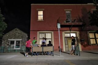 FILE - Migrant parents socialize outside the Annunciation House, June 26, 2018, in El Paso, Texas. A Texas judge ruled against the state attorney general on Tuesday, July 2, 2024, in his effort to shut down a migrant shelter in El Paso that he claimed encourages illegal migration. (AP Photo/Matt York, File)