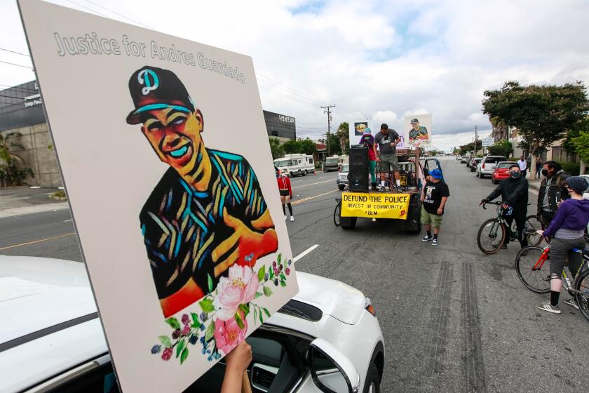 GARDENA, CA - JUNE 28: Relatives of Andres Guardado, who was fatally shot by a sheriff's deputy in Gardena, and civil rights activists participate in rally seeking justice for Andres Guardado on Sunday, June 28, 2020 in Gardena, CA. (Jason Armond / Los Angeles Times)