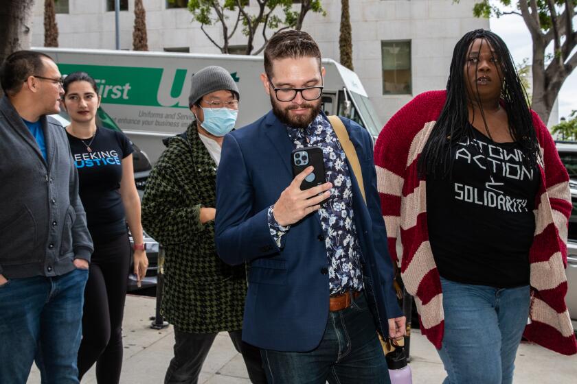 LOS ANGELES, CA - MAY 31: Ricci Sergienko and Ms. Italy, protesters who were charged with multiple misdemeanors for going onto the City Council floor, head to a pretrial hearing at Clara Shortridge Foltz Criminal Justice Center, Los Angeles, CA. (Irfan Khan / Los Angeles Times)