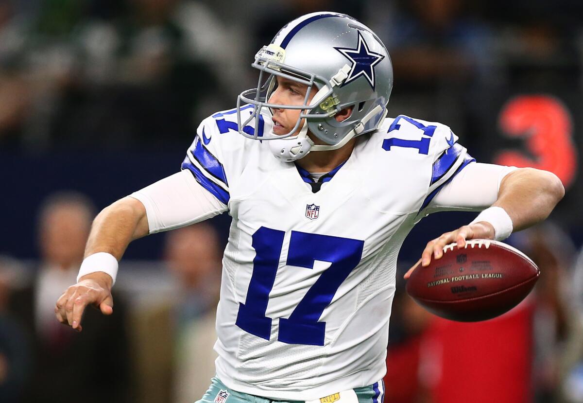 Cowboys quarterback Kellen Moore looks down field before throwing an interception against the Jets during the first half.