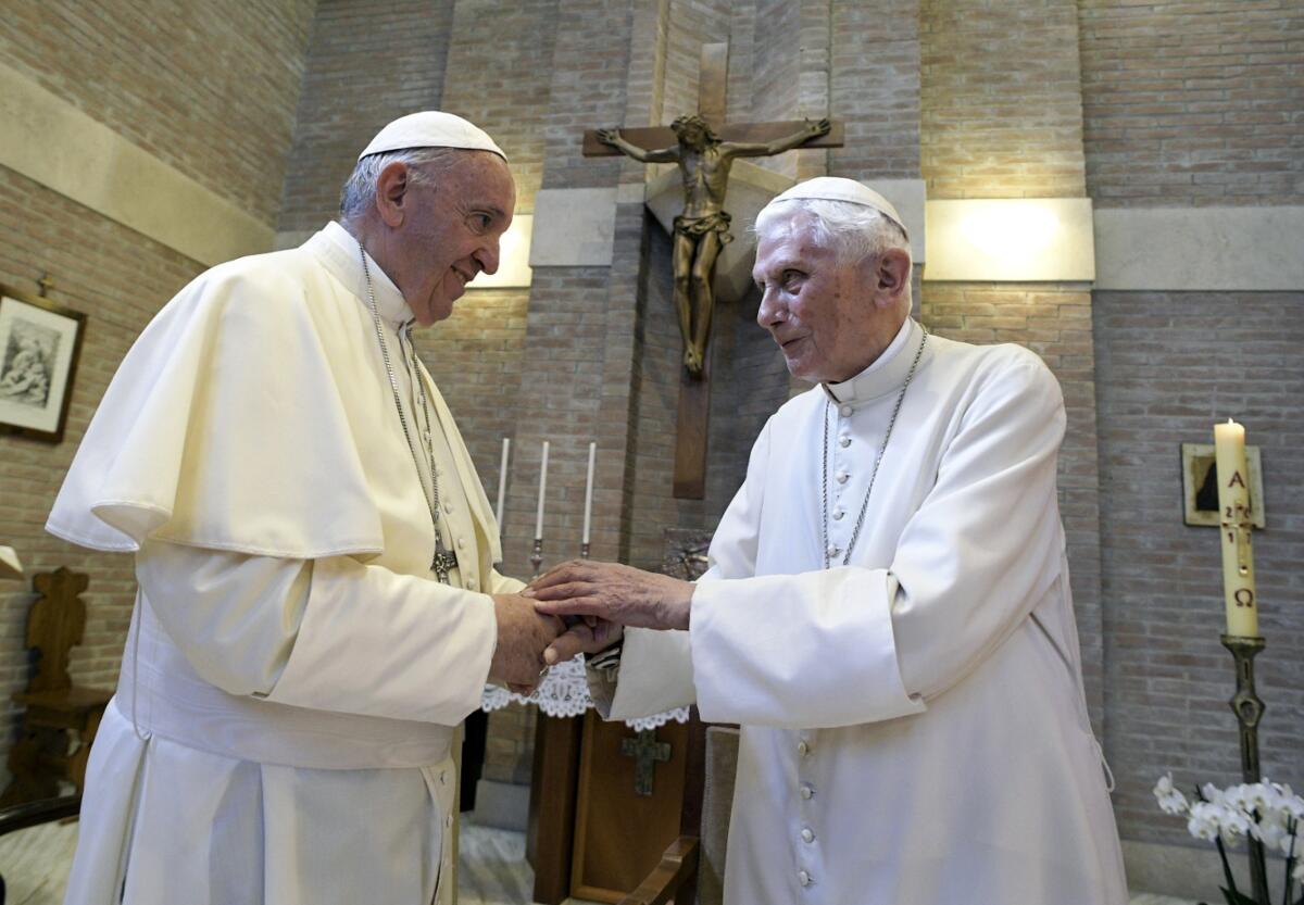 Pope Francis, left, and Pope Benedict XVI