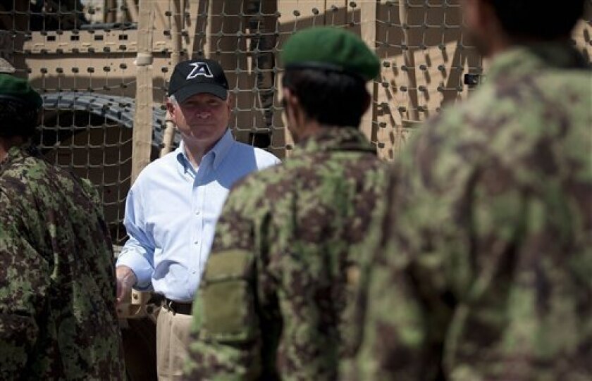 Defense Secretary Robert Gates greets Afghanistan National Army troops while visiting soldiers from the 1st Battalion, 502nd Infantry Regiment, at combat outpost Senjaray outside Kandahar, Afghanistan, Friday, Sept. 3, 2010. (AP Photo/Jim Watson, Pool)
