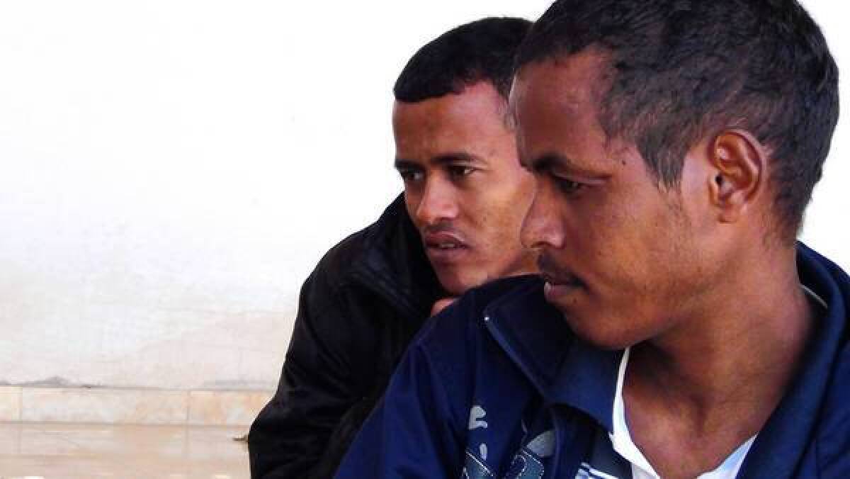 Frezzghi Geremedhin, left, sits with fellow Eritrean Tesfalem Zeru at a safe house in the Sinai Desert. Both men escaped their captors after months of torture.