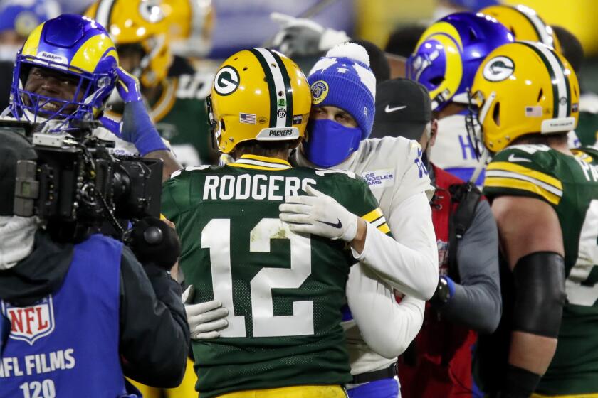 Green Bay Packers quarterback Aaron Rodgers (12) is congratulated by Los Angeles Rams quarterback Jared Goff after an NFL divisional playoff football game Saturday, Jan. 16, 2021, in Green Bay, Wis. The Packers defeated the Rams 32-18 to advance to the NFC championship game. (AP Photo/Matt Ludtke)