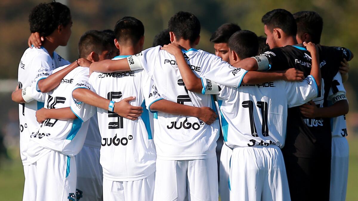 Players from an under-16 team huddle before an Alianza de Futbol Hispano showcase game in San Bernardino this summer.