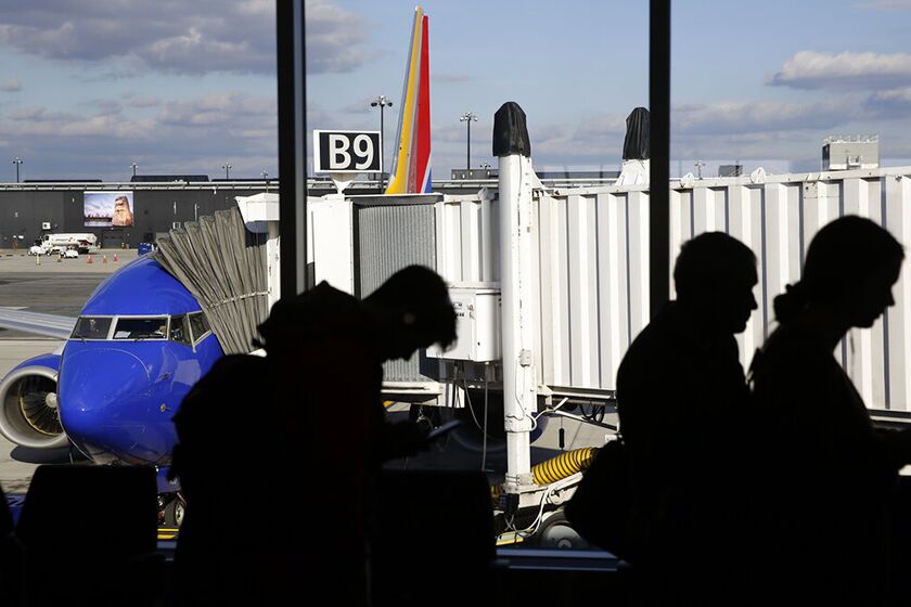 Travelers board a flight at Baltimore-Washington International Thurgood Marshall Airport in Linthicum, Md.
