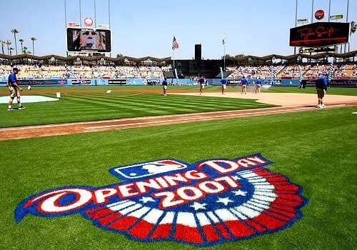 Dodgers ground crew members prepare the field an hour before the first pitch is thrown in the Dodgers' 2007 home opener against the Colorado Rockies.