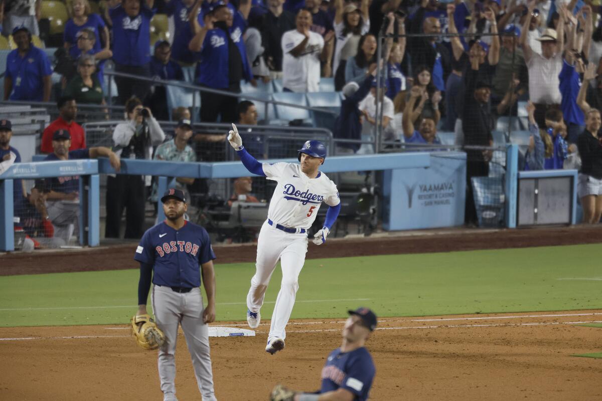 Freddie Freeman, Boston'a karşı sekizinci vuruşta yaptığı grand slam'in ardından birinci üssü dönerken kutlama yapıyor.